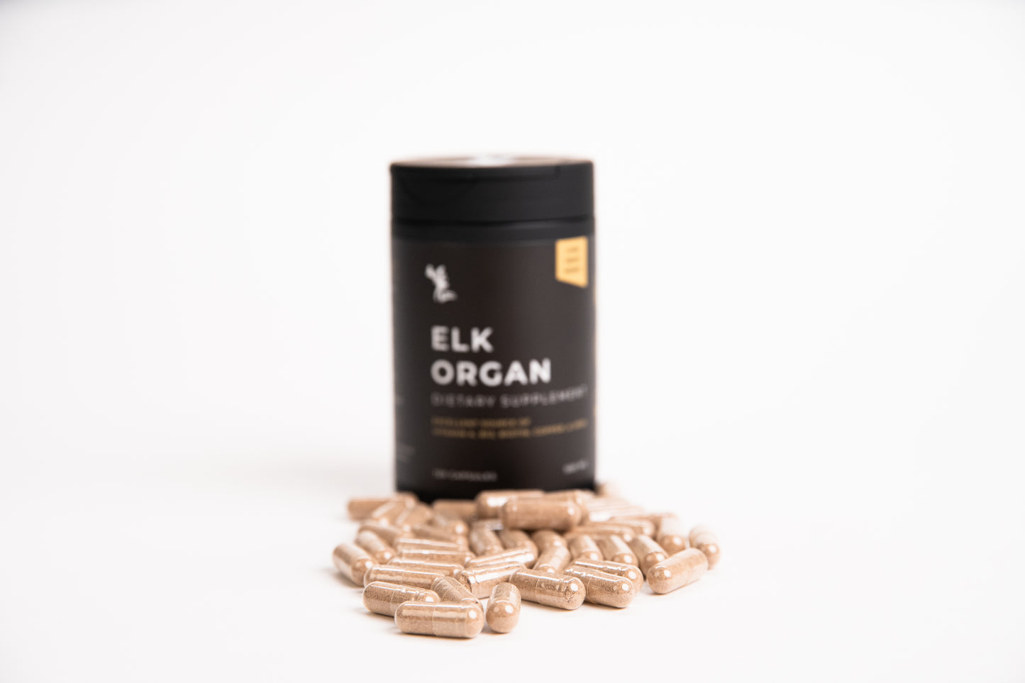 Black container labeled 'Elk Organ' with capsules on a white background