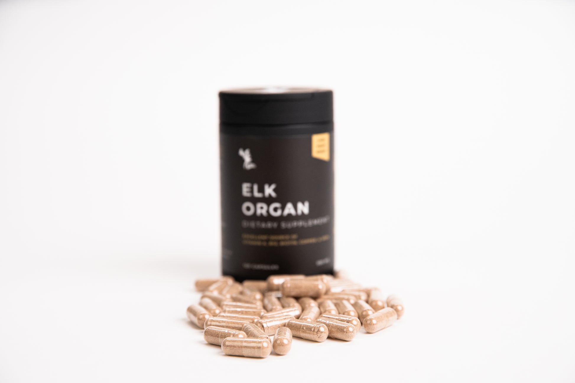 Black container labeled 'Elk Organ' with capsules on a white background