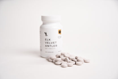 Bottle of Elk Velvet Antler supplement with tablets on a white background