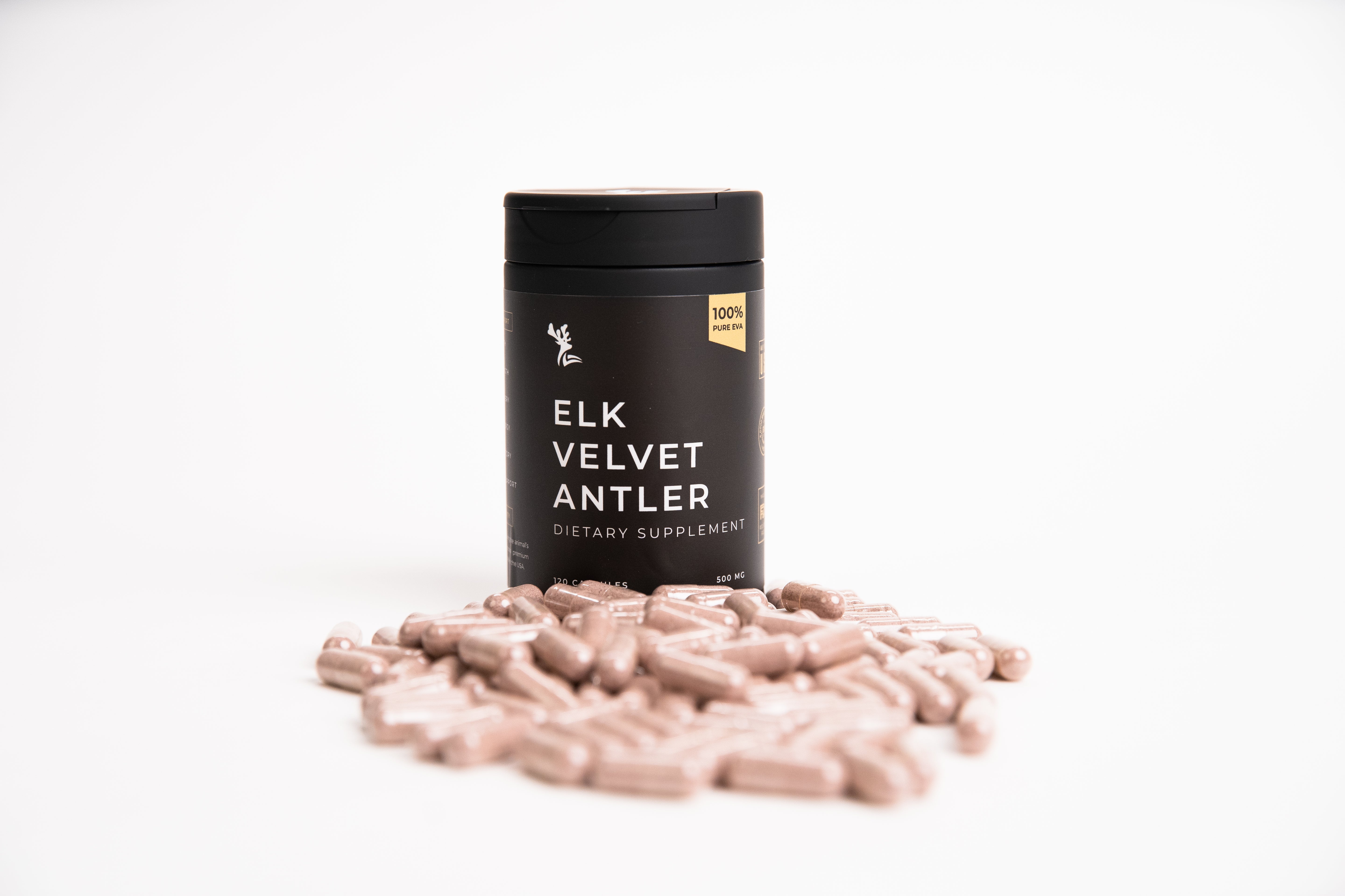 Supplement container labeled 'Elk Velvet Antler' with tan capsules on a white background